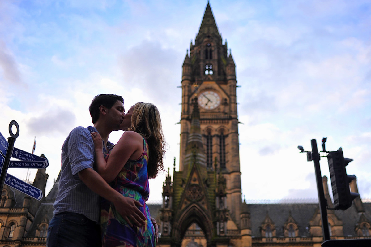 Couple kissing in front on main manchester city square in the UK
