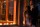 a bride and a groom are illuminated by orange lights at night at the outside of chateau polonez in houston tx