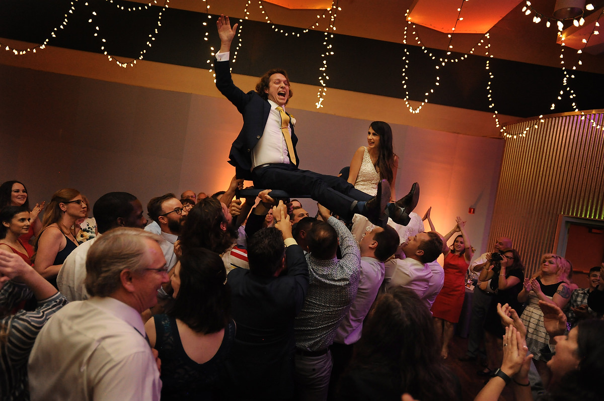 birde and groom are held in arms during their reception party in denton texas