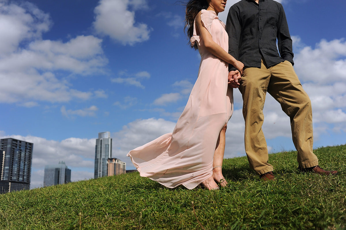 a bride and a groom pose with the austin skyline in the back