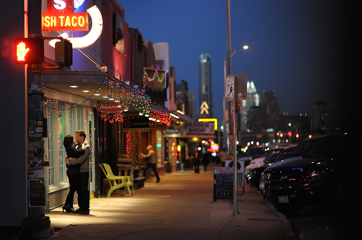 a couple is huging outside the street at dawn in downtown austin texas