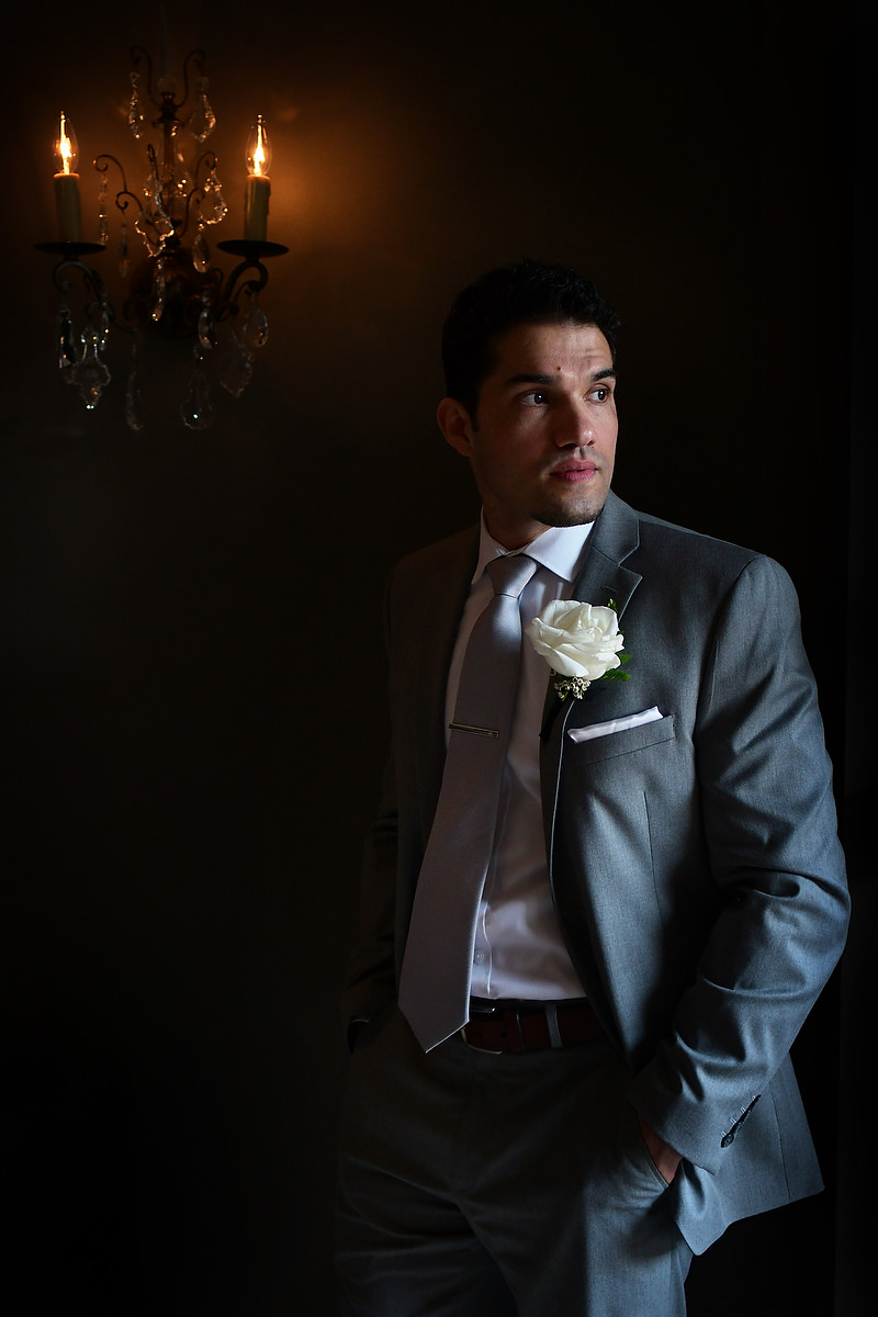 groom posing for his portrait in zaza hotel in houston