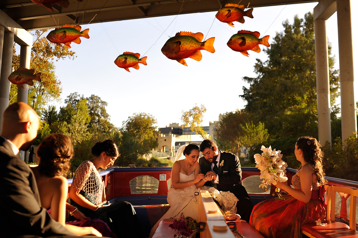 a wedding couple and their friends are having fun in a boat on their way to the reception in san antonio texas