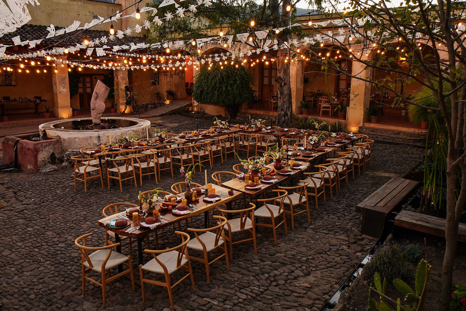 the decorations of the patio of the ex hacienda san antonio in oaxaca for a mexican wedding reception at night